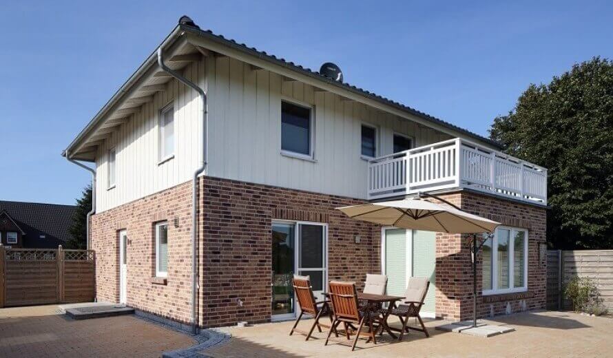 Einfamilienhaus mit einer Eternit Cedral Boden-Deckel-Schalung in der Farbe Kreideweiß c07.